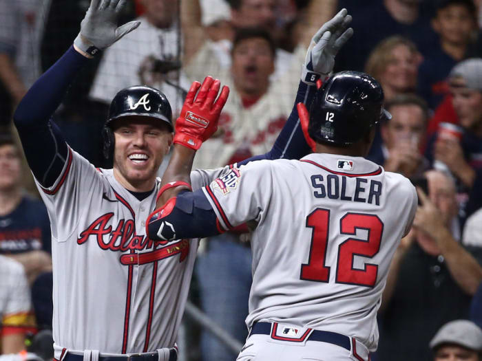 Atlanta Braves designated hitter Jorge Soler (12) celebrates with first baseman Freddie Freeman (5) after hitting a three-run home run against the Houston Astros.